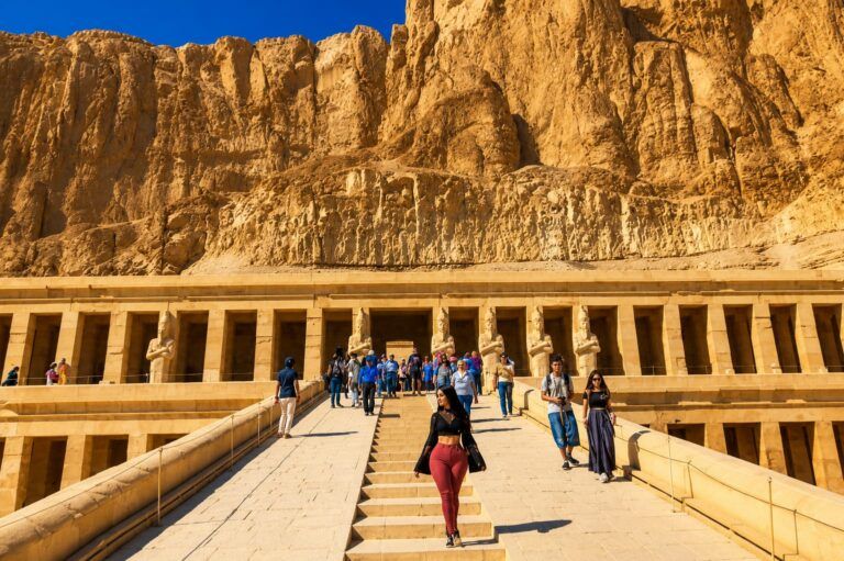 6-day Cairo Luxor and Aswan private Egypt tour package Travelers exploring the Great Pyramids of Giza in Cairo Karnak Temple in Luxor during a private Egypt tour Valley of the Kings royal tombs in Luxor, Egypt Temple of Hatshepsut on the west bank of Luxor Luxor Temple illuminated at sunset in Egypt Philae Temple on Agilkia Island in Aswan Traditional boat sailing near Philae Temple in Aswan Aswan High Dam overlooking Lake Nasser Private Egypt holiday featuring Cairo, Luxor, and Aswan Egyptologist guide leading a tour through ancient Egyptian temples Grand Egyptian Museum visit during a Cairo sightseeing tour Ancient hieroglyphs inside a temple in Luxor Six-day Egypt vacation exploring Cairo, Luxor, and Aswan Private cultural tour through Egypt's most famous archaeological sites